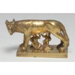An early 20th century gilt brass desk model, The Capitoline Wolf, she stands, suckling Romulus and