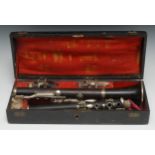 A 19th century rosewood clarinet, nickel plated mounts, 69cm long overall, fitted tooled morocco