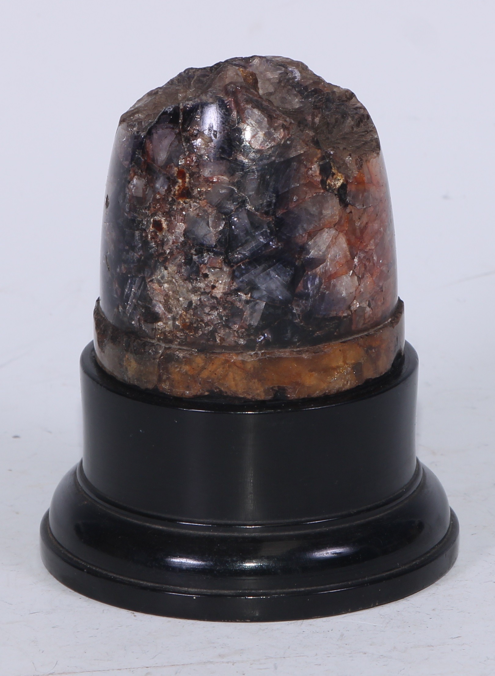 A Derbyshire Blue John section, mounted for display as a desk weight, ebonised plinth, 12cm high