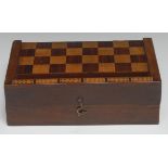 A 19th century mahogany and parquetry rectangular games box, inlaid for chess, cribbage board