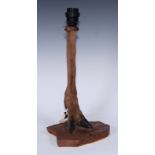 Taxidermy - a deer hoof, leg and forelock, mounted as a table lamp, rustic wood base, 42.5cm high