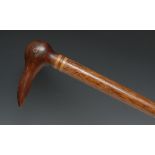 A Pitcairn Island walking stick, the pommel carved as the head of a bird, the cane 85.5cm long