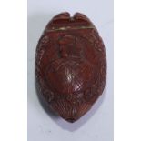 A 19th century coquilla nut snuff box, hinged cover carved in relief with a portrait, to verso