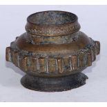 An Islamic bronze vessel, the side with a band of geometric lugs, spreading foot, 10cm diam, 19th