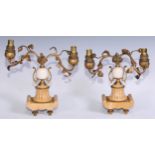 A pair of early 20th century gilt metal and sienna marble mantel candelabra, the scrolling