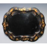 A post-Regency toleware shaped oval tray, decorated in gilt with a band of flowers and leaves,