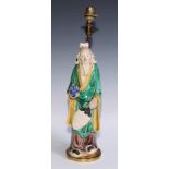 A Chinese sancai figure, of an immortal holding a peach, 32.5cm high, mounted as a lamp, 40cm to