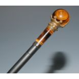 An early 20th century walking cane, globular tiger's eye pommel, ebonised bamboo shaft, 85cm long