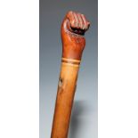 A Pitcairn Island walking cane handle, typically carved as a fist, 19th century malacca shaft,