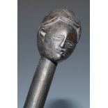 Tribal Art - an African club, the anthropomorphic terminal carved as a head and face, 76cm long