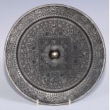 A Chinese bronze Archaic hand mirror, well cast in the typical Han Dynasty manner with TLV