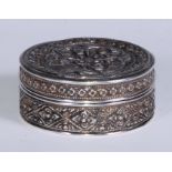 An Indian silver circular box, chased with flowerheads and scrolling fruiting foliage, 7cm diam,