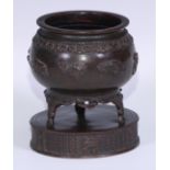 A Chinese bronze censer, cast and applied with a crane in flight amongst scrolling clouds, the