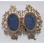 A 19th century gilt brass easel double photograph frame, oval apertures, the border pierced and