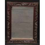 A Chinese hardwood rectangular mirror, carved with a border of flowers, stiff leaves and trellis,