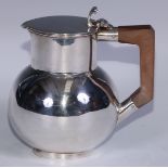 An Art Deco period silver ovoid water jug, hinged cover with scroll thumbpiece, bakelite handle,