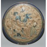 A Chinese silk circular panel, depicting an immortal holding a ruyi sceptre, riding a kylin, an