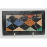 A pietra dura rectangular desk weight, inlaid in lapis lazuli, agate and specimen stones with a