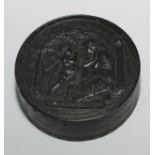 A 19th century pressed horn circular snuff box, the cover with an allusion to Cupid and Psyche,