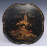 A Japanned lobed circular tray, decorated in polychrome in the manner of Chinese lacquer with a