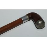 An early 20th century novelty system cane walking stick, the L-shaped handle enclosing a pipe,