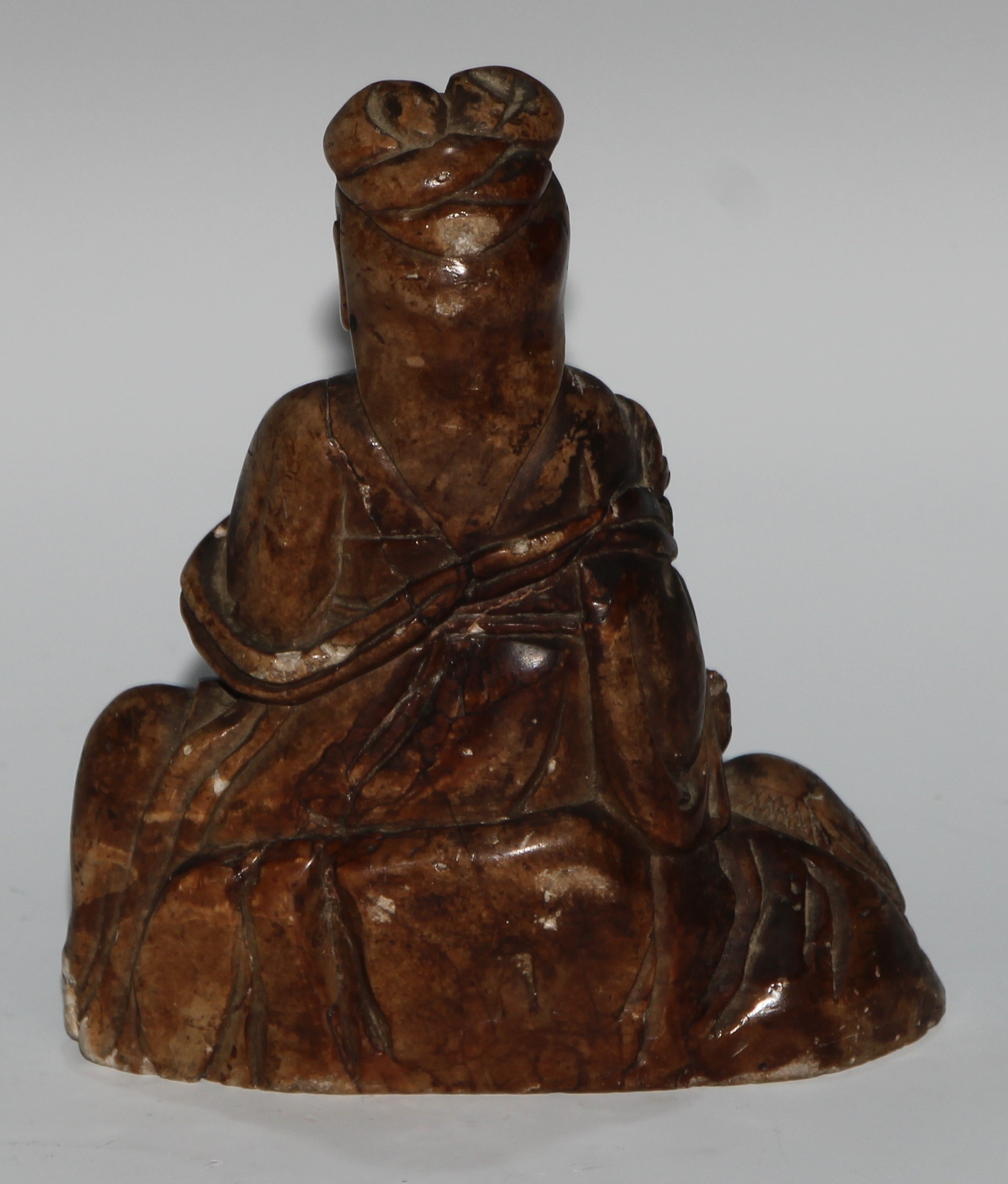 A Chinese soapstone figure, carved as guanyin, seated, serene, holding a lotus, a bird at her - Image 4 of 4