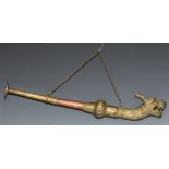 A Tibetan copper and brass rkangling [kangling] trumpet, makara sea dragon terminal, 37cm long