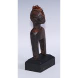 Tribal Art - a West African heddle pulley, carved as a stylised figure, 17.5cm high, mounted for