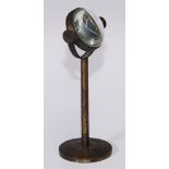 Microscopy - a 19th century lacquered brass table top bull's eye lens, circular base, 14.5cm high