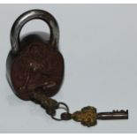 A Tibetan bronze and steel padlock, cast with Tara, 11cm long