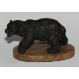 Continental School, a dark patinated bronze, of a bear, oval base, 19cm long