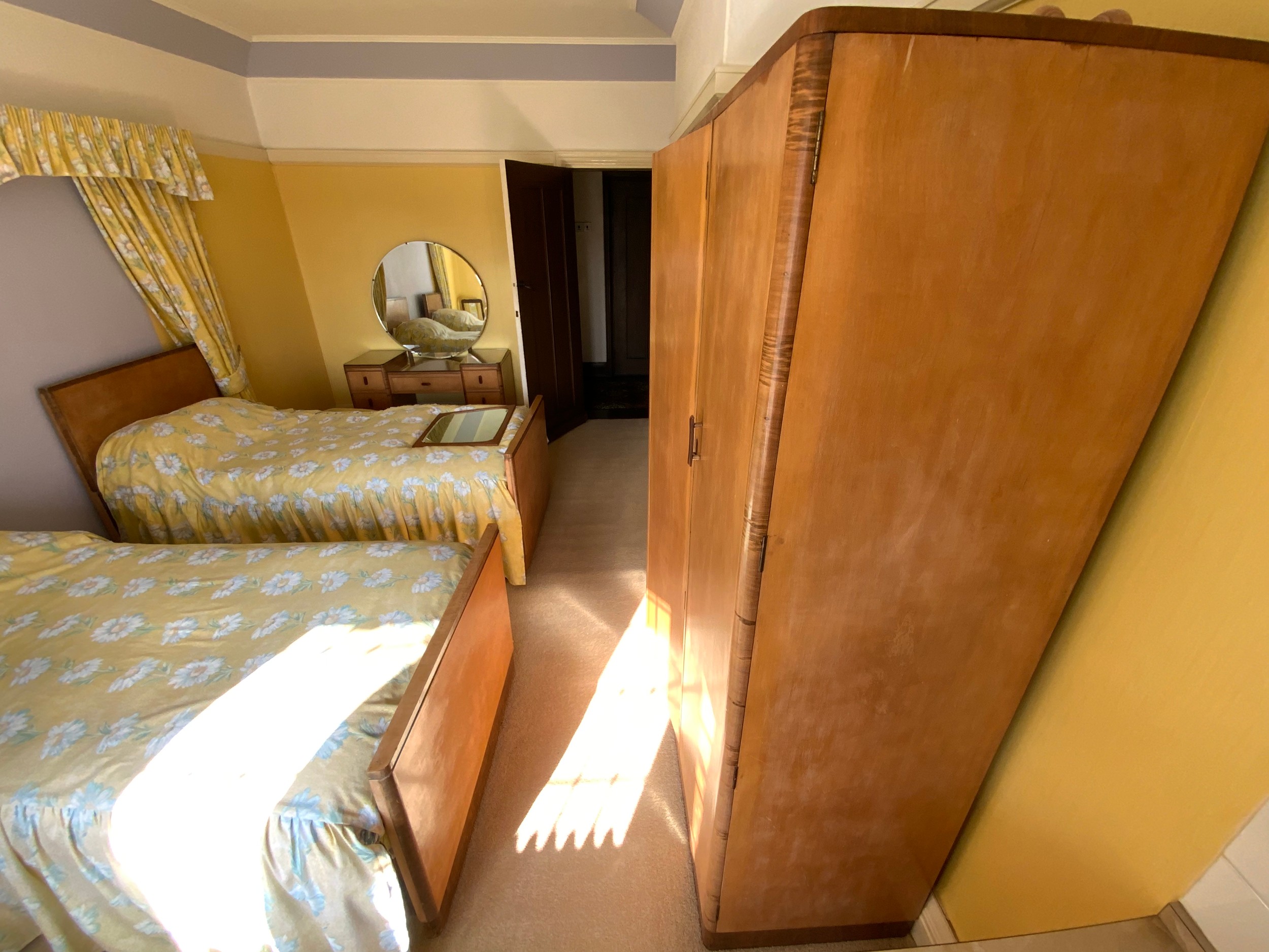 An Art Deco bedroom, comprising triple wardrobe, lady's double door wardrobe, shaped rectangular