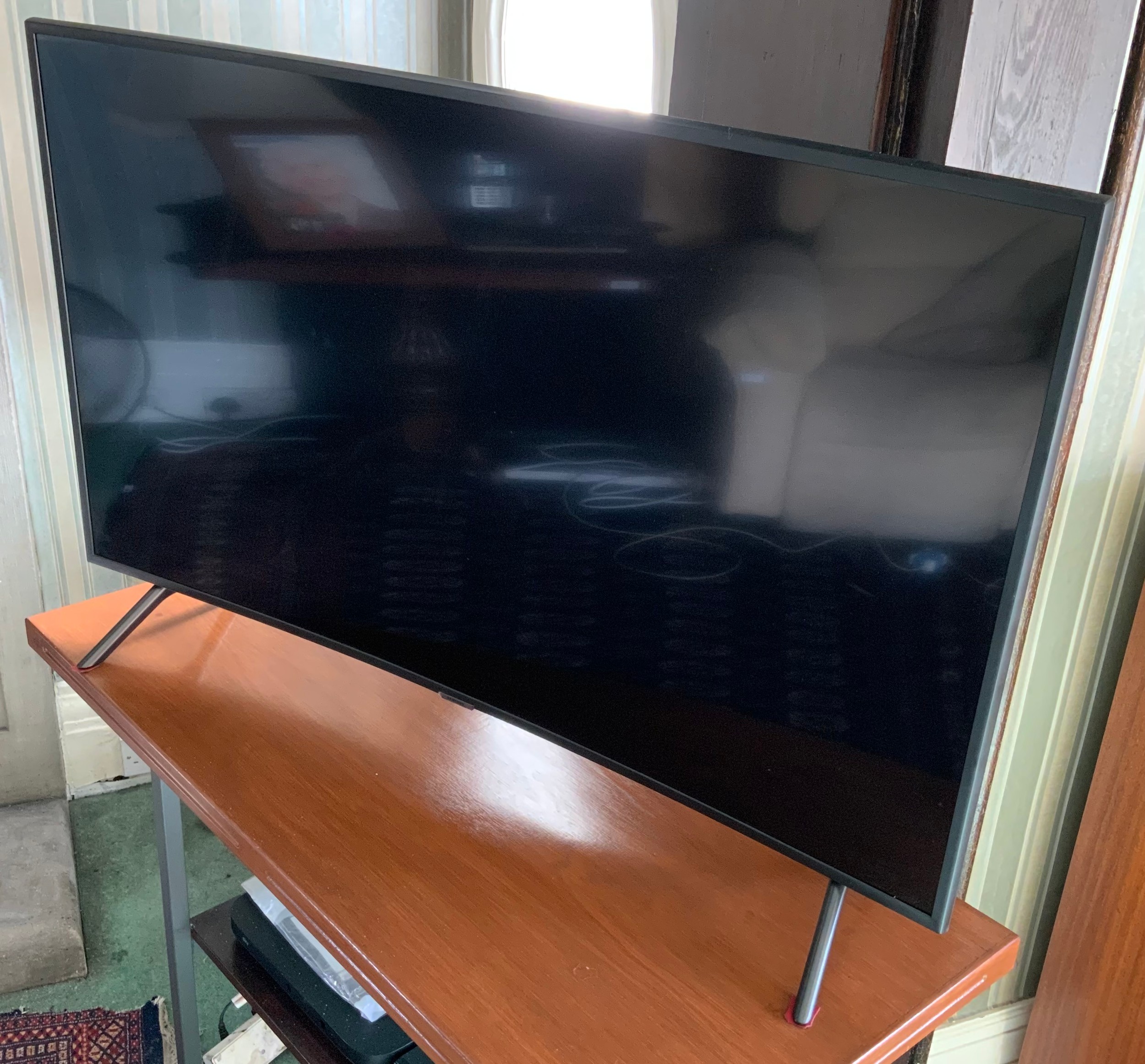 A Samsung television and remote control, curved 48in screen, model code UE49RU7300KXXU,; a Samsung