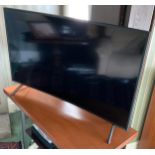 A Samsung television and remote control, curved 48in screen, model code UE49RU7300KXXU,; a Samsung