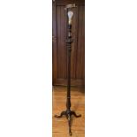 An early 20th century mahogany standard lamp, reeded column, tripod legs, pad feet ** We would