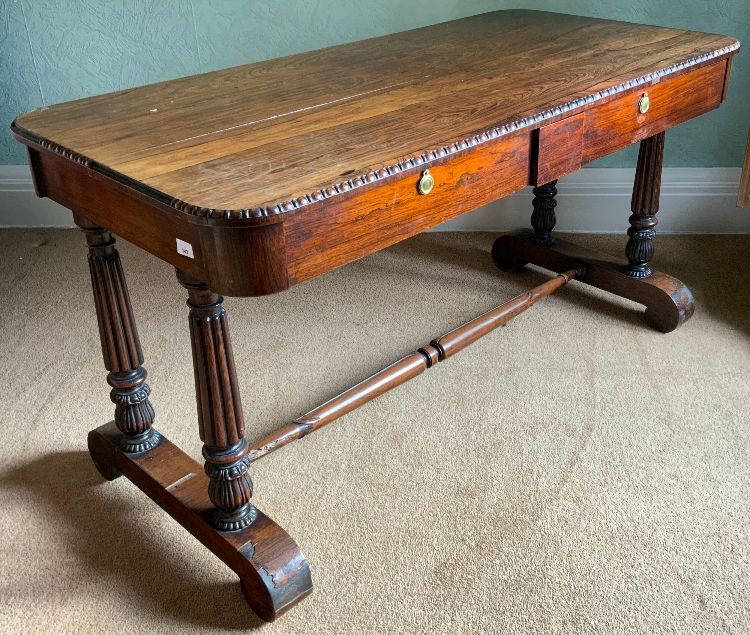 A William IV rosewood sofa table, rounded rectangular top, egg-and-dart border, the frieze with