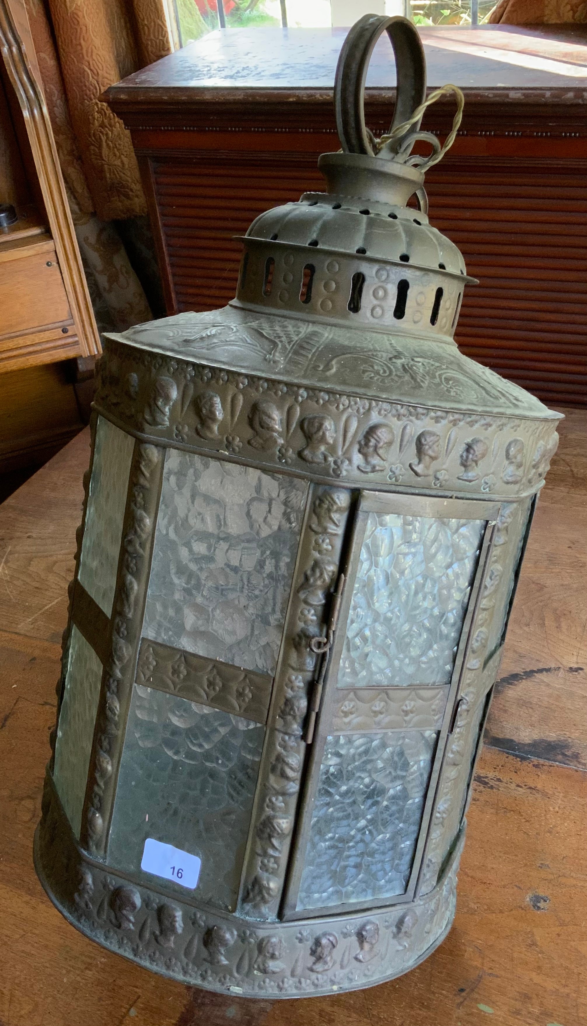 A late 19th/ early 20th century hall lantern, embossed with classical busts, bubbles frosted glass