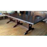 A large rectangular mahogany stained dining table, moulded edge, central stretcher with three fluted