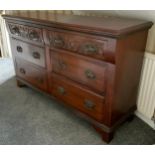 An early 20th century mahogany sidebaord, with six drawers, carved with swags, Art Nouveau