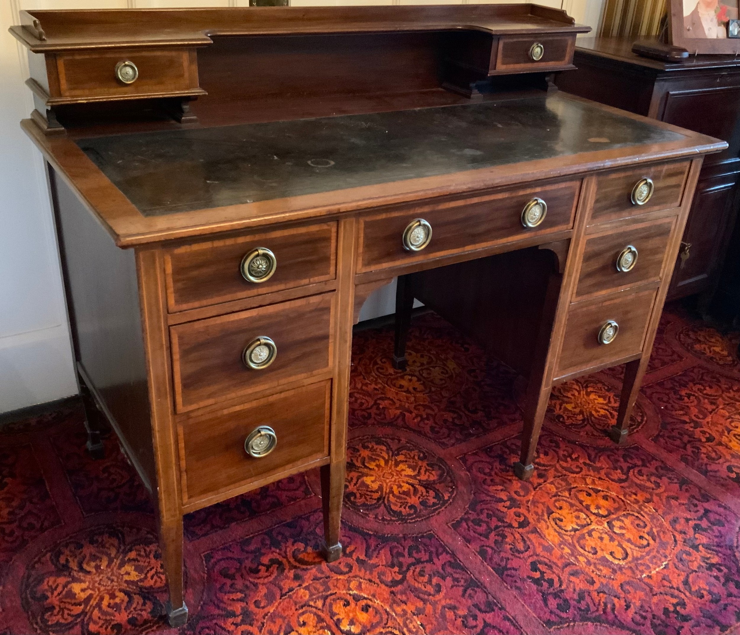 An Edwardian mahogany and satinwood strung writing desk, by Waring, the superstructure fitted with