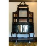 A Victorian ebonised chiffoniere, with blind fret swan neck pediment above two shelves and seven