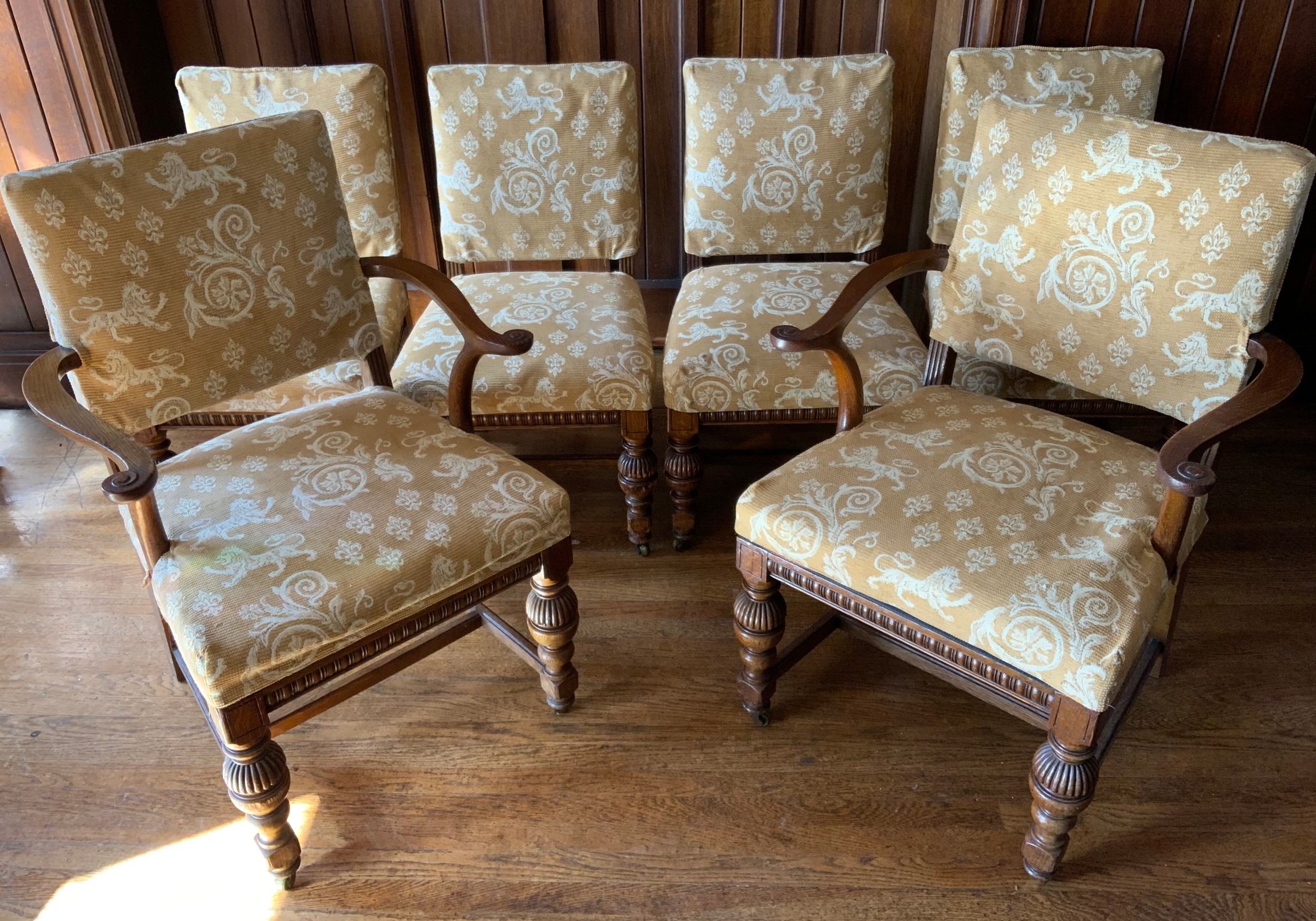 A set of twelve oak dining chairs, by Thomas Turner of Manchester, stuffed over back and seats,