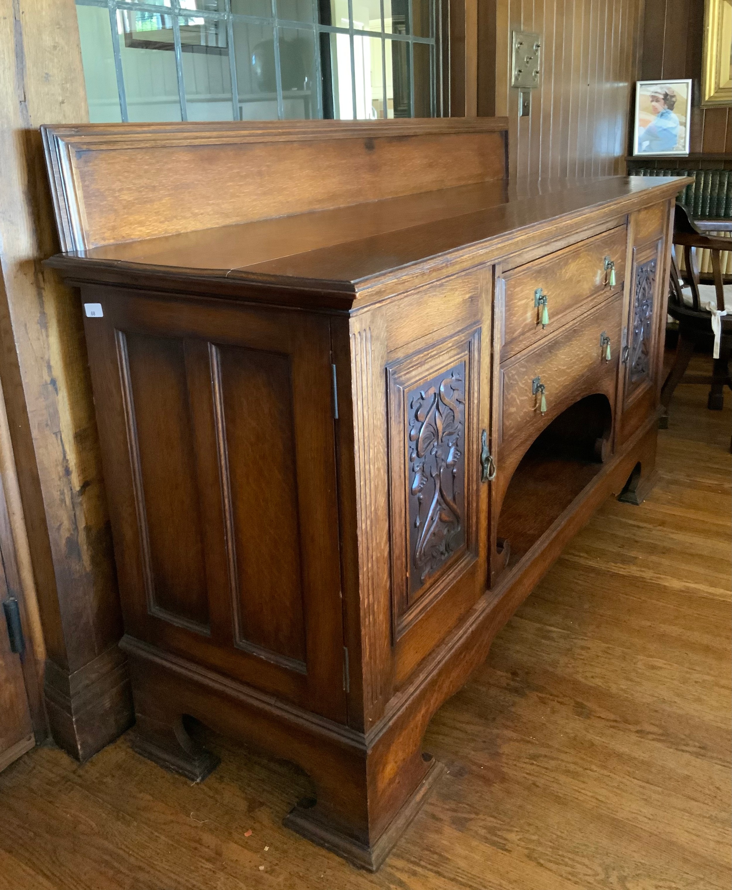 An Edwardian oak sideboard, fitted with two drawers, and two panelled doors, carved with scrolls, - Image 2 of 4