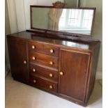 An oak sideboard, with four drawers flanked by cupboard doors, now converted to a dressing chest,