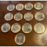 A set of thirteen French circular disc, each engraved in monochrome with a religious scene, 6cm diam