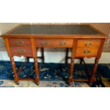 A Victorian mahogany writing desk, with inset writing surface above an arrangement of five