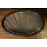 An early 20th century mahogany oval mirror, ribbon tied reeded frame, 62cm x 87cm ** We would please