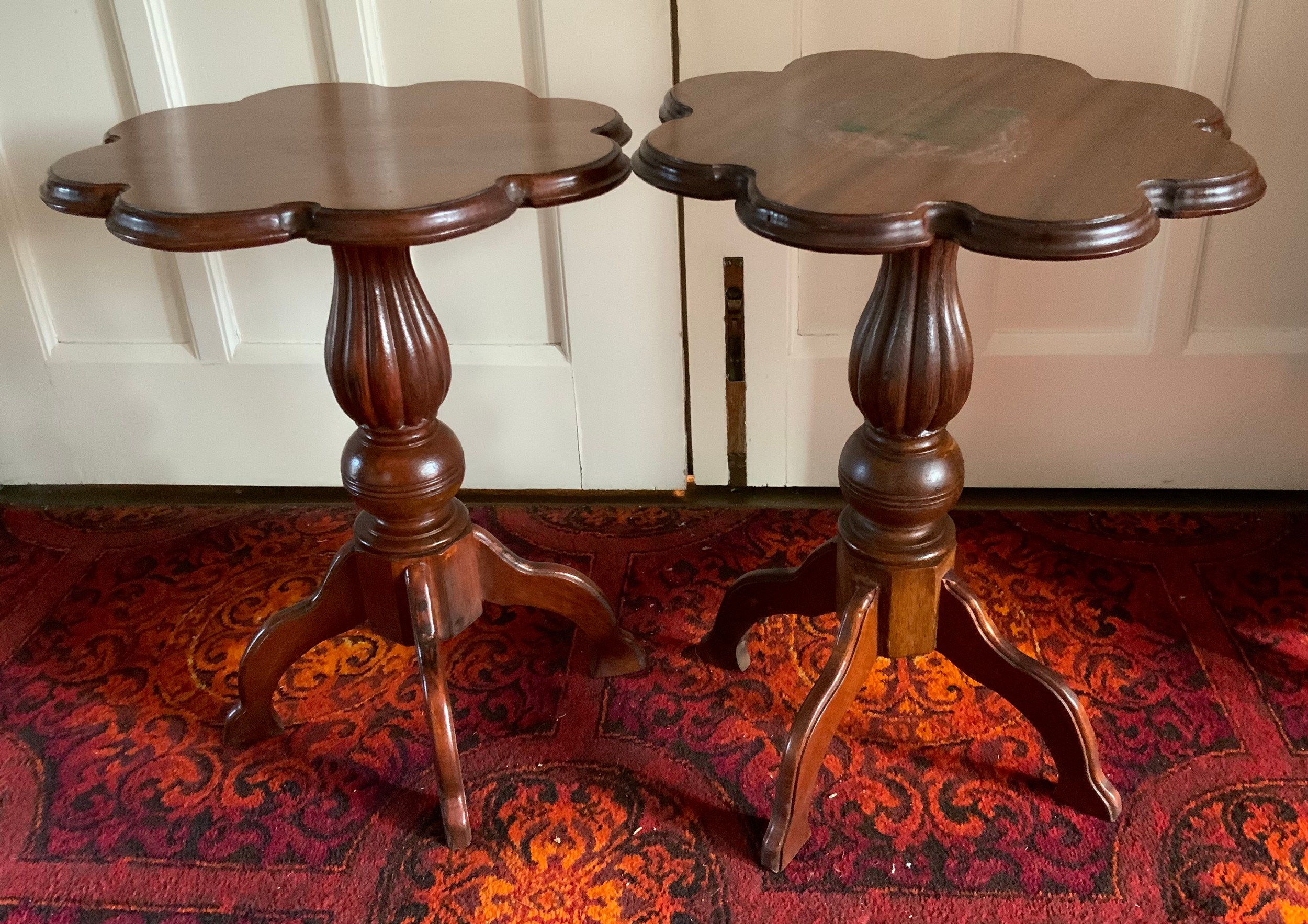 A pair of 20th century mahogany occasional tables, shaped circular tops, fluted bulbous columns,