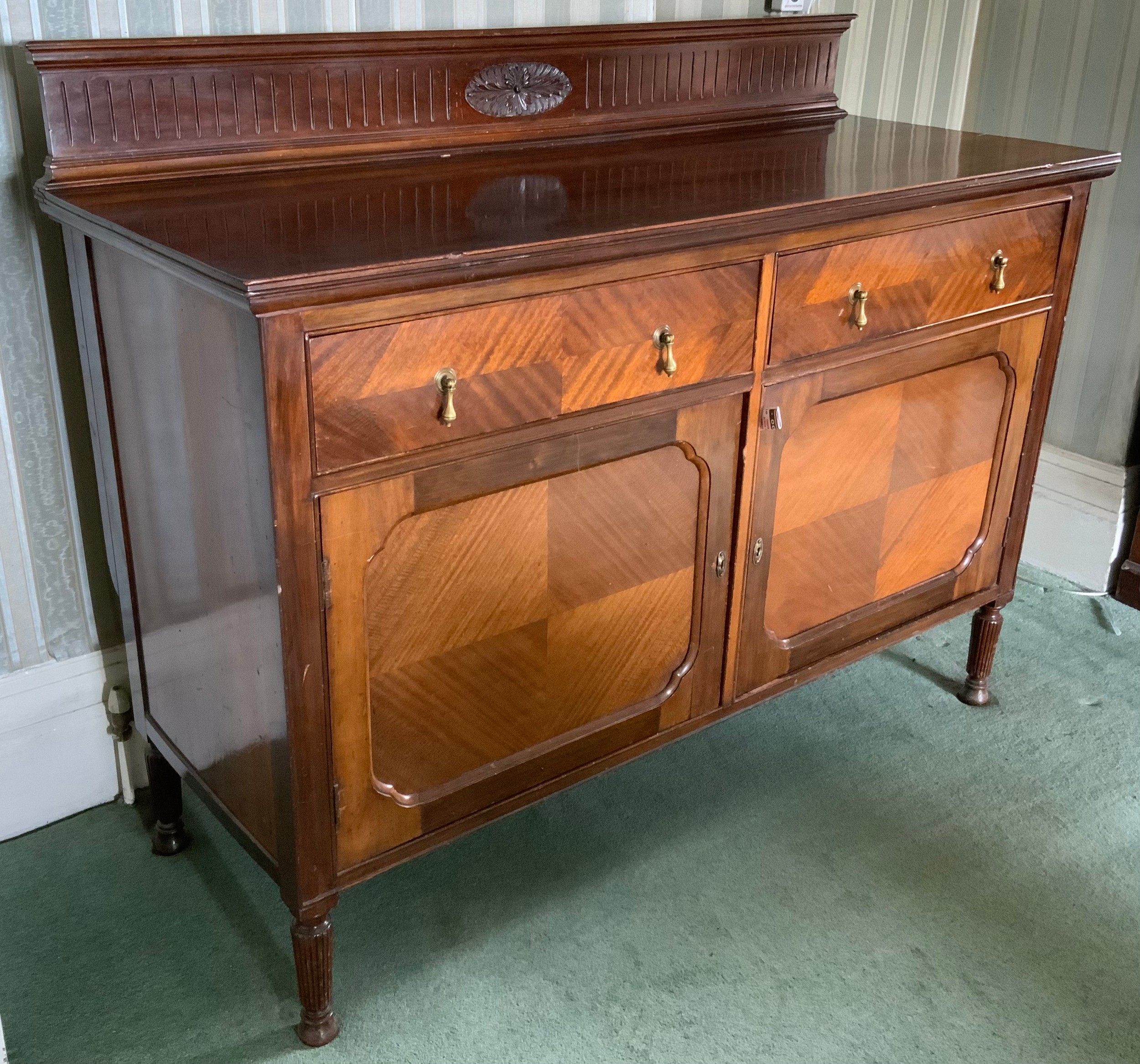 An early 20th century mahogany sideboard, fluted back gallery, two drawers above tow fielded