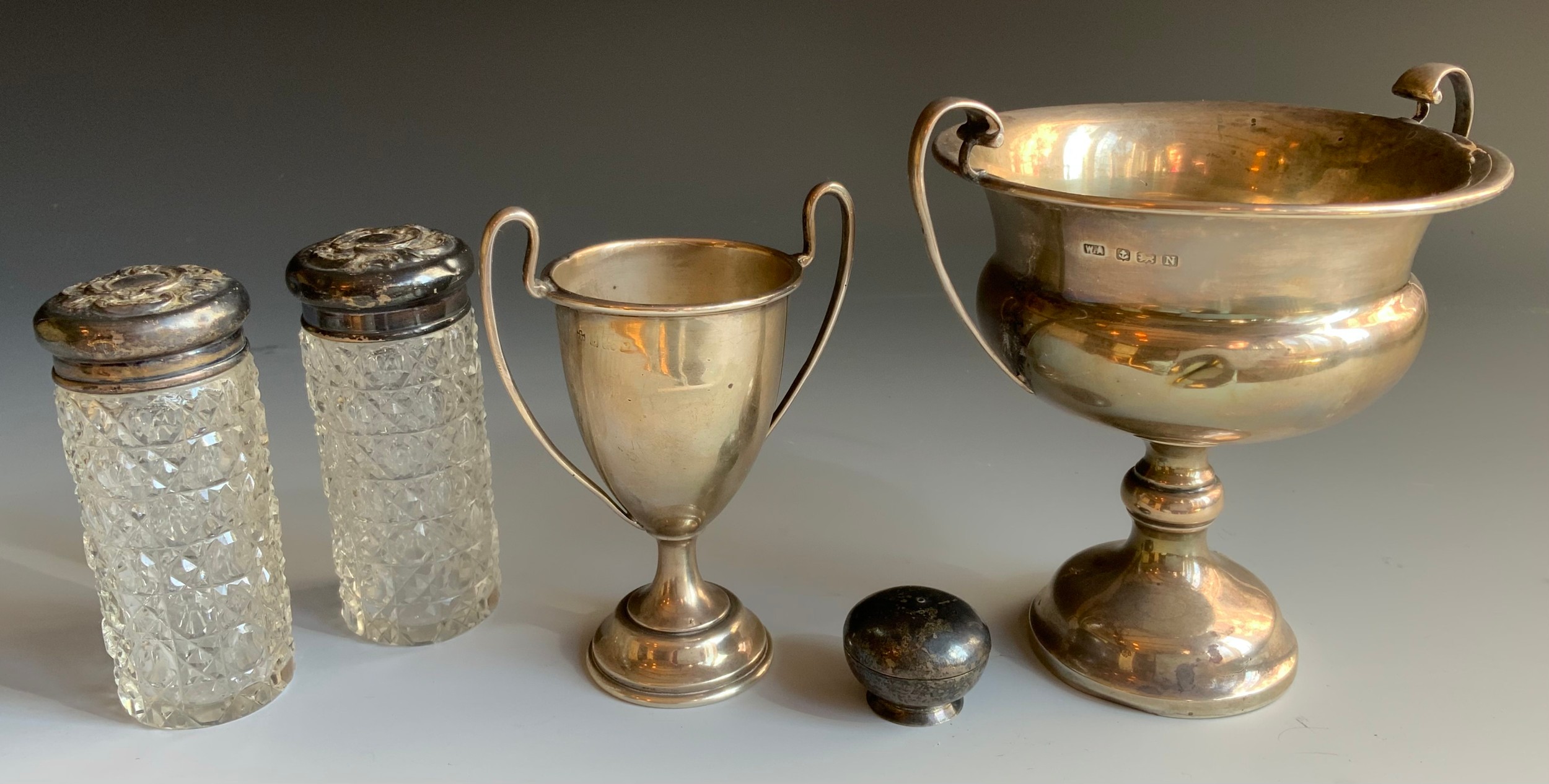 A silver two handled trophy cup, 11cm high, Birmingham 1935; another, smaller, 144g (4.64ozt); two